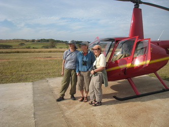 Next to helicopter with 2 friends