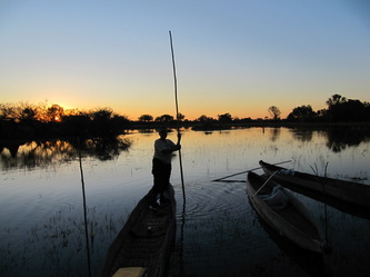 in dug out canoe at sunset (in Botswana)