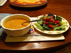 Photo of bowl of soup and plate of salad